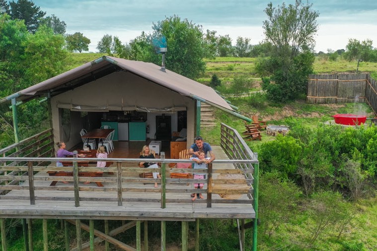 AFRICAMPS---INGWE-(16) family-on-deck-of-boutique-glamping-tent-at-africamps-at-ingwe-in-plettenberg-bay-garden-route